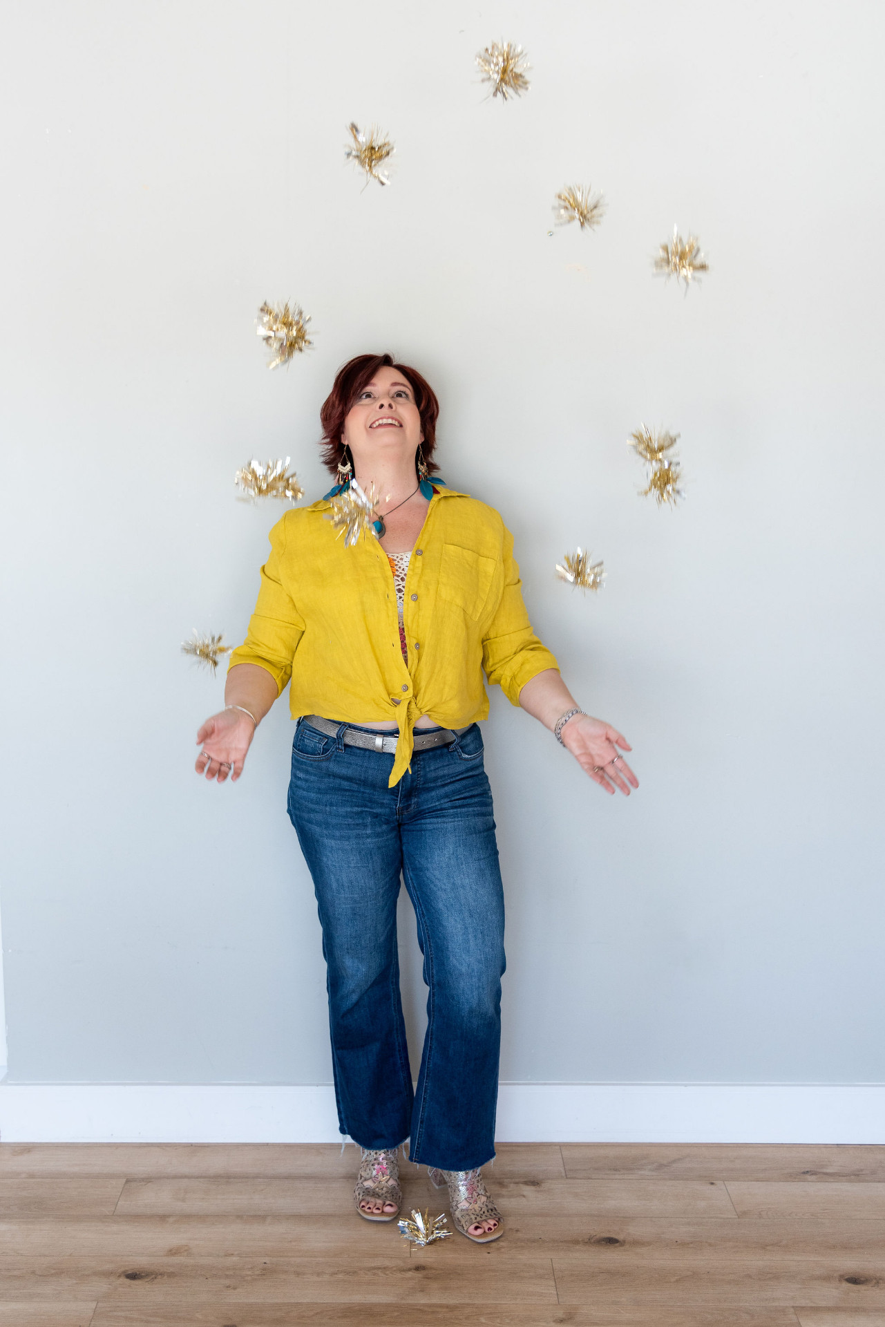 Melanie Rhora, keynote speaker, tossing gold confetti